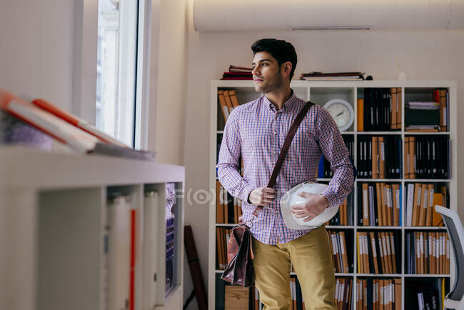 Schöner junger Mann schaut im Büro weg — Stockfoto