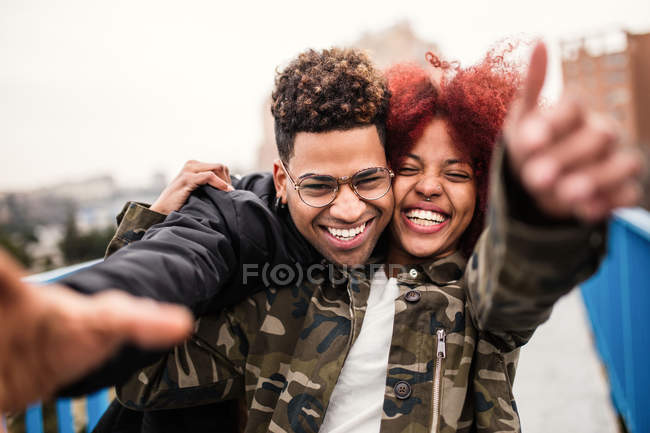 Cheerful couple embracing and laughing — Stock Photo