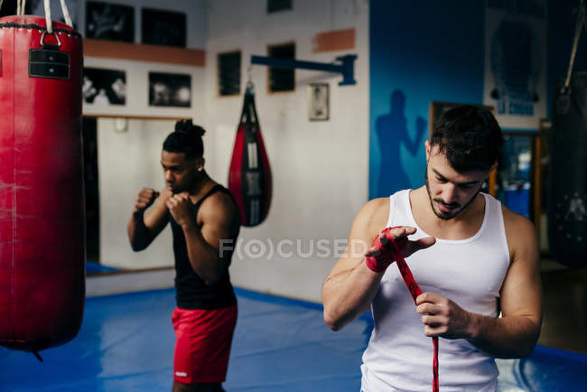 Fighter putting on bandage on hands — Stock Photo