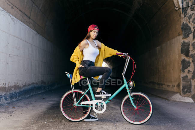 Mujer de pie con bicicleta - foto de stock