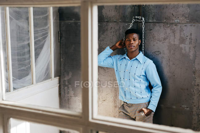 Nero uomo guardando fuori sporco finestra — Foto stock