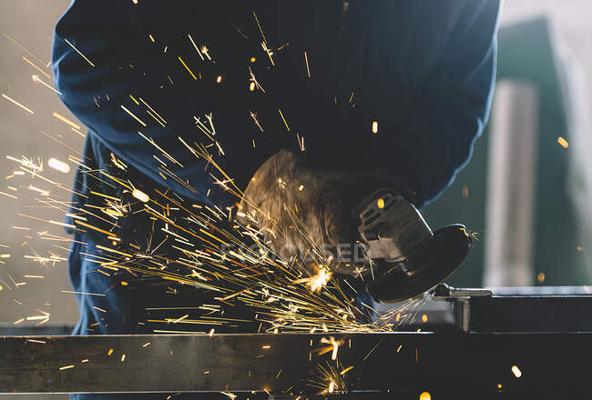 Man works with grinder machine. — Stock Photo