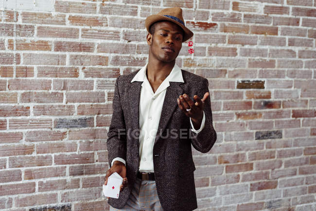 Man with playing cards throwing dices — Stock Photo