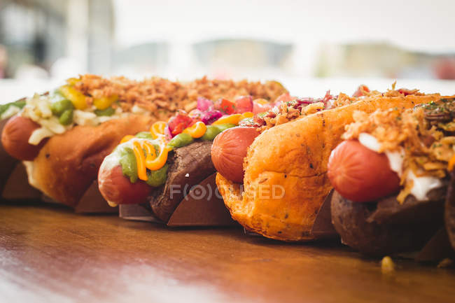 Rangée de divers hot-dogs servis — Photo de stock