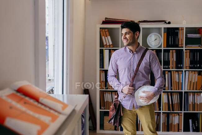 Handsome young man looking away in office — Stock Photo