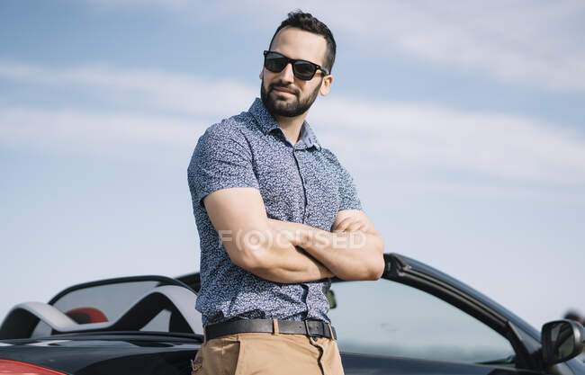 Homme attrayant posant en voiture convertible. — Photo de stock