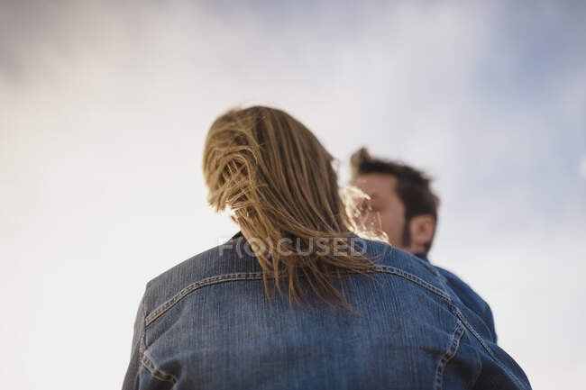 Back view of a womans hair blowing by the wind — Stock Photo