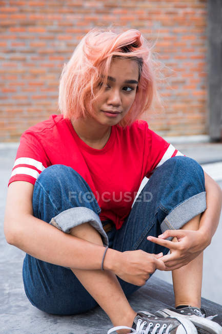 Sad woman sitting on ground — Stock Photo