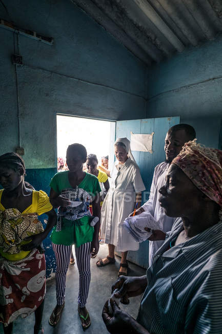ANGOLA - AFRICA - APRIL 5, 2018 - Black women walking out of clinic — Stock Photo