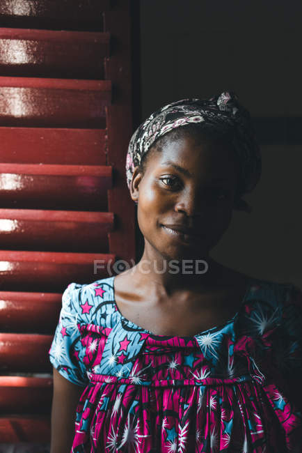 CAMEROON - AFRICA - APRIL 5, 2018: Pretty young African woman standing and looking at camera — Stock Photo