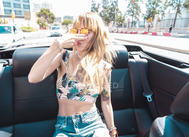 Young woman riding cabriolet — Stock Photo
