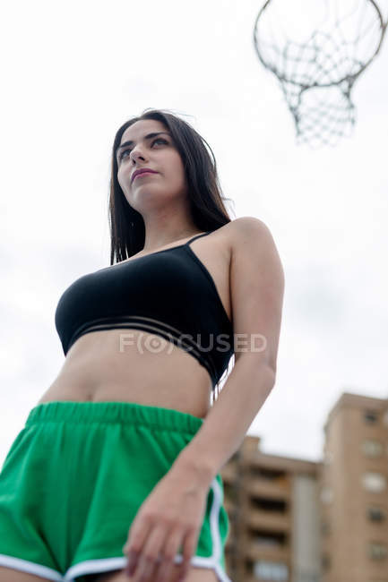 Young fit woman in sportswear standing in city — Stock Photo