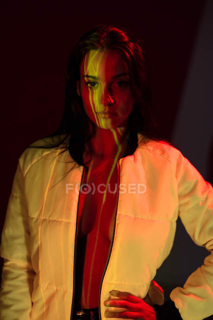 Portrait of Pretty young woman in white jacket with light stains on face looking at camera — Stock Photo