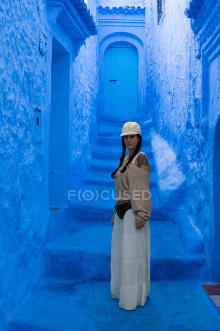 Woman standing on blue dyed street, Morocco — Stock Photo