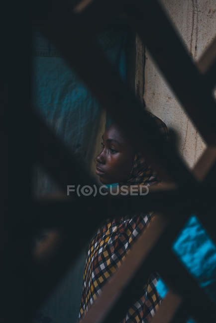 CAMEROON - AFRICA - APRIL 5, 2018: Thoughtful young ethnic woman standing at wall and looking away — Stock Photo