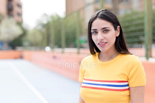 Portrait of Young woman standing on sports ground — Stock Photo