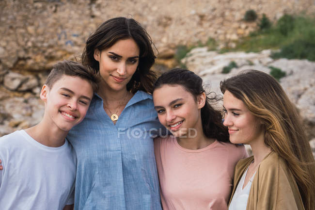 Portrait of woman and teenagers standing outdoors — Stock Photo