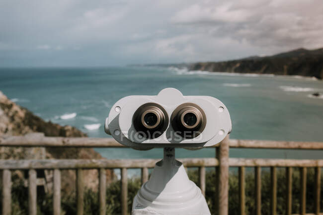 Gray colored binoscope and view to the bay in cloudy day. — Stock Photo
