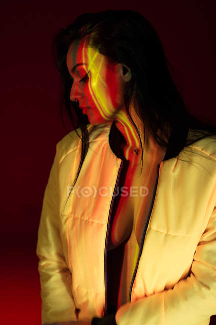 Pretty young woman in white jacket with light stains on face — Stock Photo