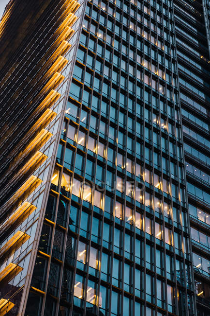 Крупним планом освітлена висока офісна вежа ввечері — стокове фото