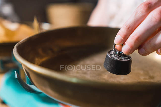 Female hands putting small weight on scales indoors — Stock Photo