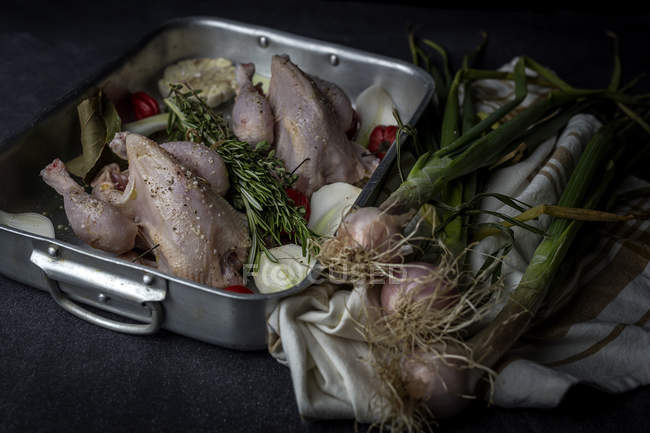 Raw whole chicken ready to roast on baking pan with ingredients — Stock Photo