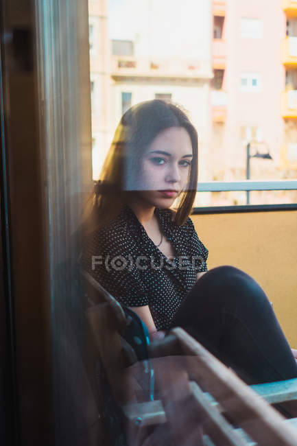 Portrait of Thoughtful woman sitting in chair — Stock Photo