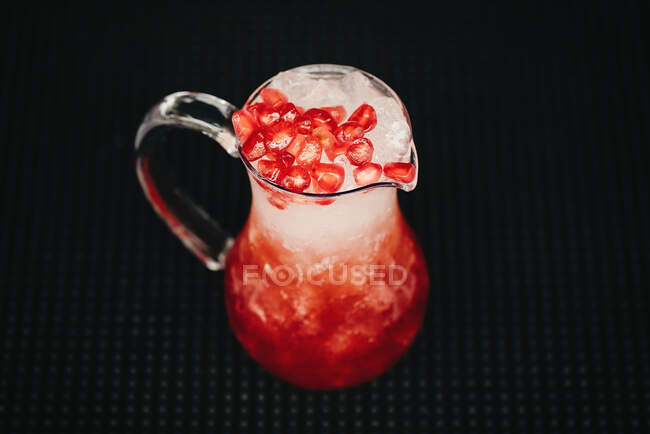 Jug with berry lemonade — Stock Photo