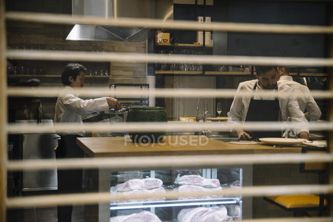 Cooks cooking in restaurant — Stock Photo