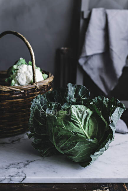 Cabbage lying near basket — Stock Photo