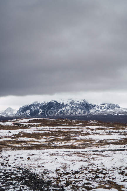 Tranquilo vale nevado com montanhas sob céu nublado, Islândia — Fotografia de Stock