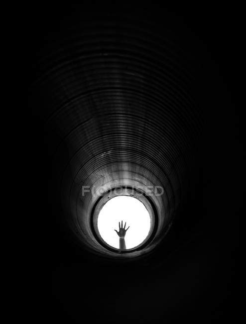 Hand in pipe in daylight — Stock Photo