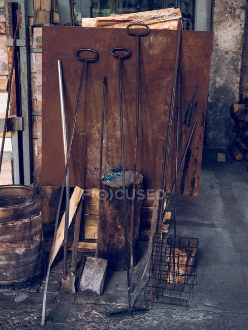 Stand with different instruments in workshop of glass factory. — Stock Photo