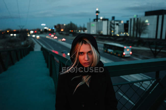 Blonde woman standing in dusk — Stock Photo