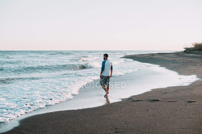 Человек, идущий по океану — стоковое фото