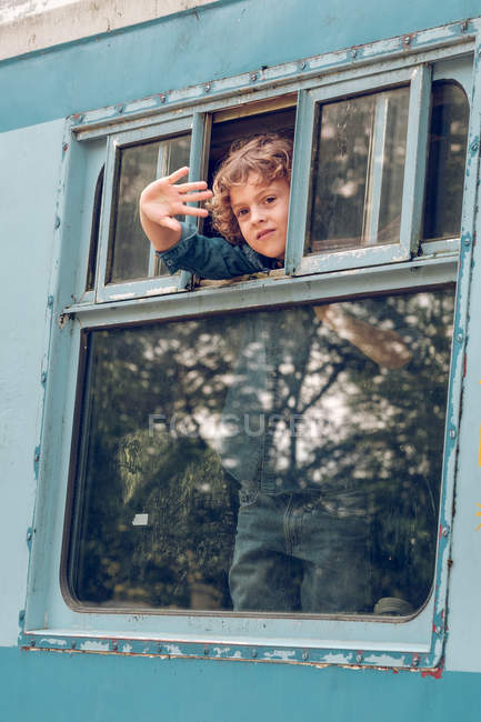 Boy standing inside of old train — Stock Photo