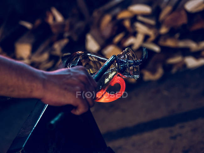 Unrecognizable craftsman forming holder on glass jug on glassblowing factory. — Stock Photo