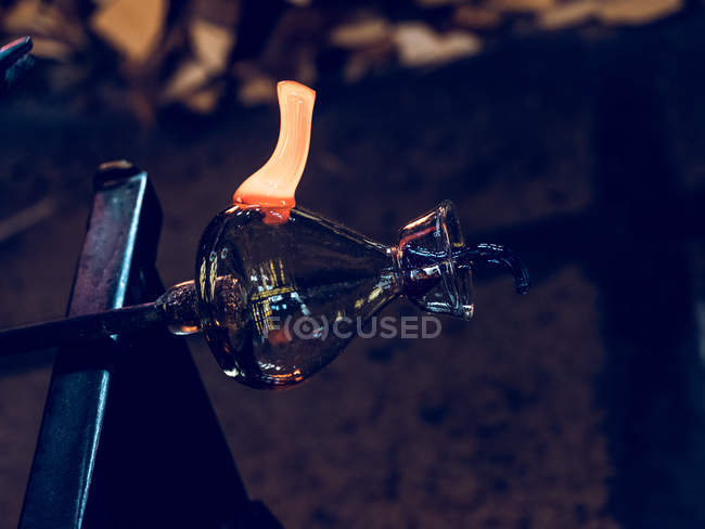 Close-up of glassblowing process of forming holder on glass jug at factory. — Stock Photo