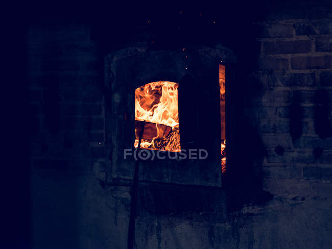 Abstract glass decoration in hot burning furnace on factory. — Stock Photo