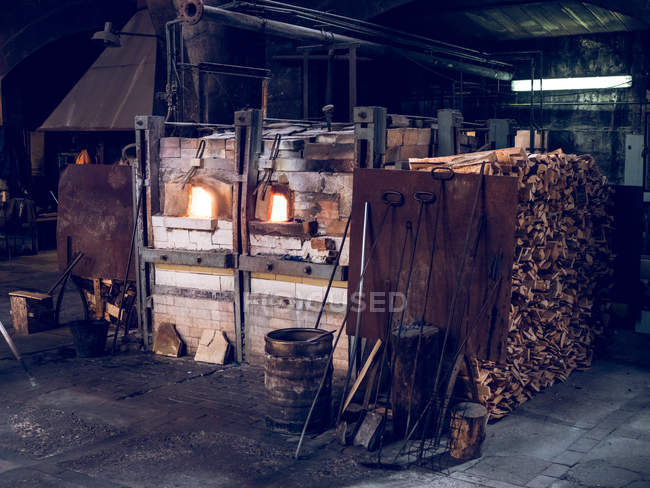Burning furnaces and different tools in room of glass factory. — Stock Photo