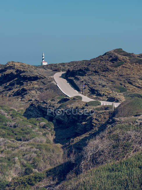 Torre del faro y carretera en las montañas - foto de stock