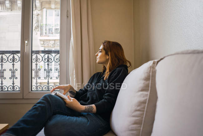 Woman relaxing with book at home — Stock Photo