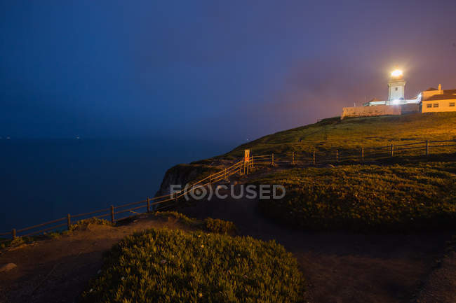 Illuminated lighthouse at night — Stock Photo