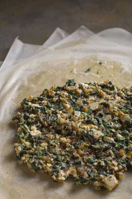 Stuffing for traditional spanakopita spinach pie on filo dough — Stock Photo