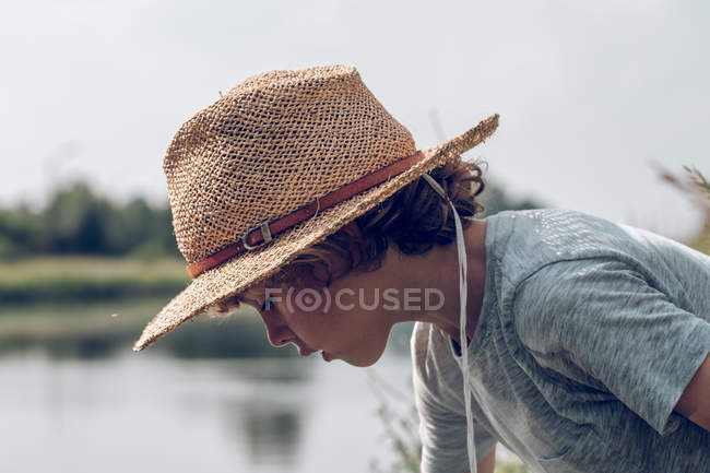 Boy playing with water in river — Stock Photo