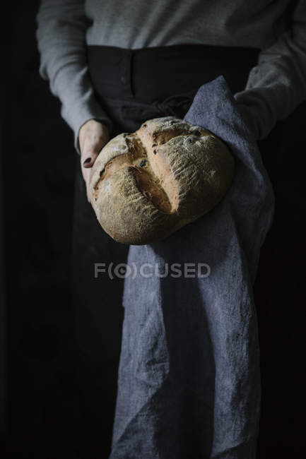 Hands holding homemade bread — Stock Photo