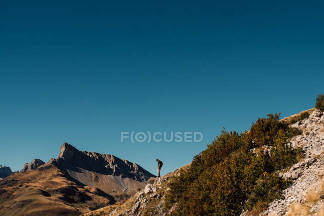 Turista de pie en la cima de la montaña - foto de stock