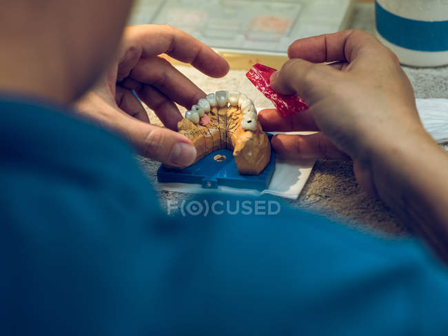Dental technician holding denture — Stock Photo
