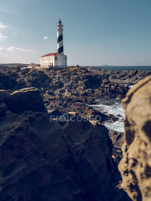 Rocky cliff and beacon — Stock Photo