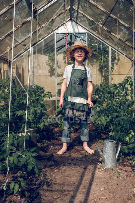 Boy standing in greenhouse — Stock Photo